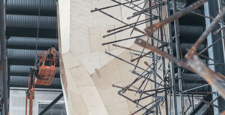 Climbing wall construction workers attaching wood panels to frame